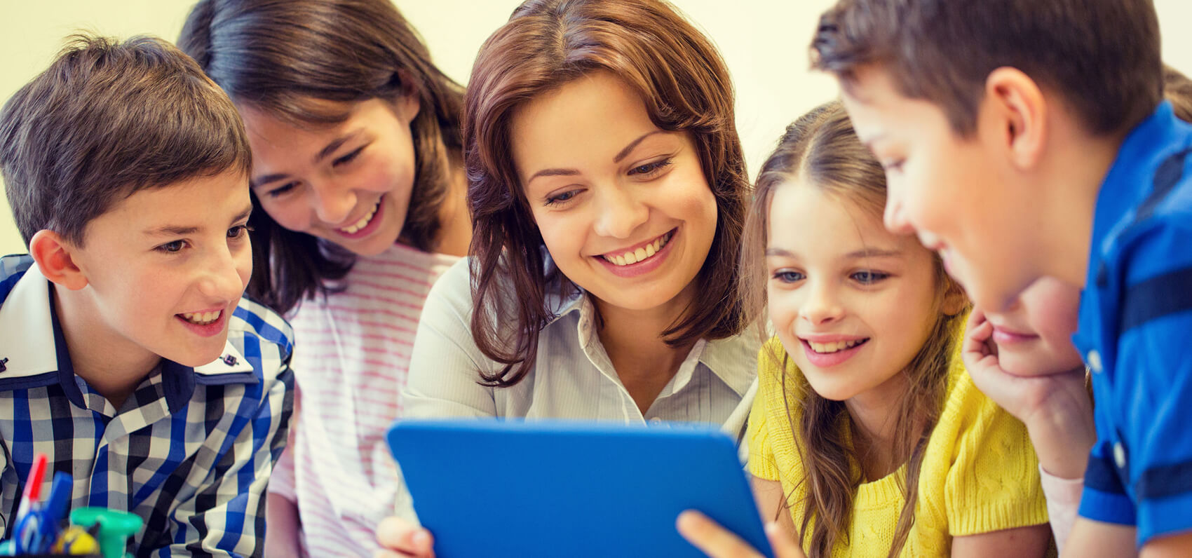 Master of Educational Technology teaching children with a mobile device